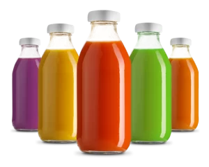 A group of bottles filled with different colored juice.