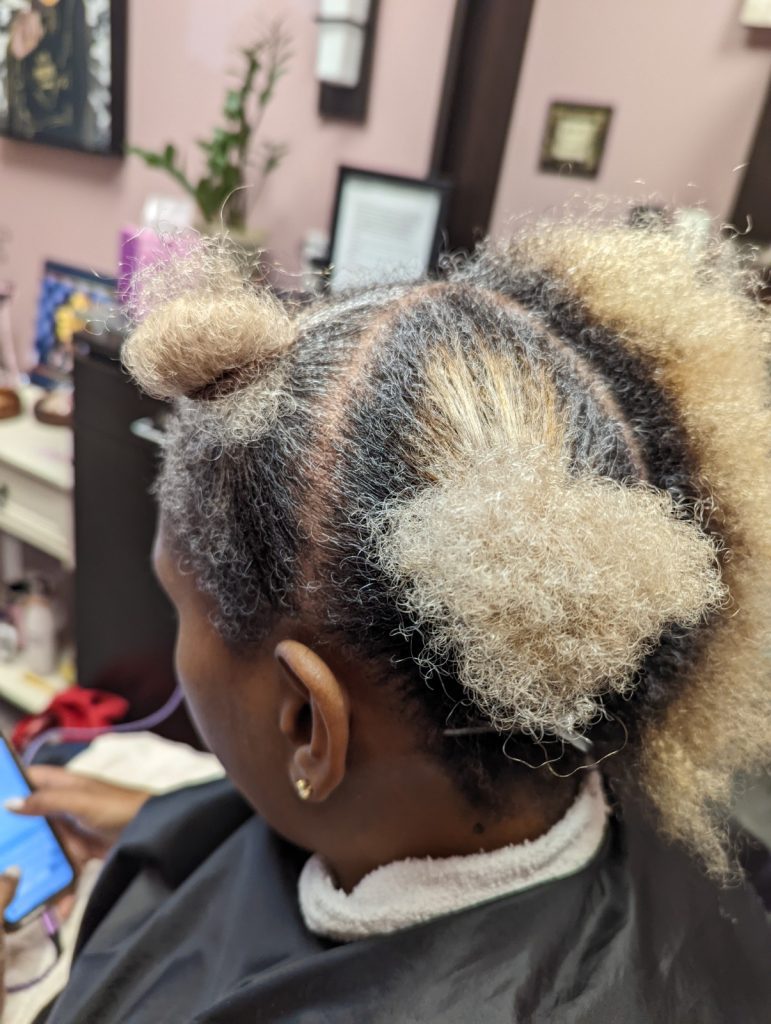 A woman with a hair style that looks like a cat.