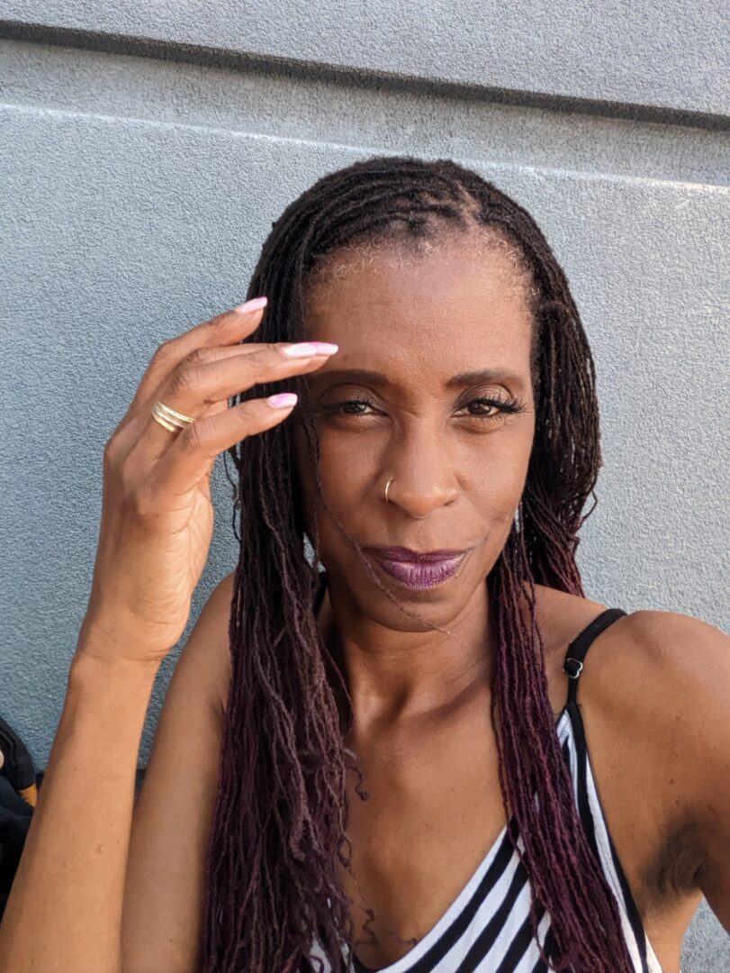 A woman with purple hair and black makeup.